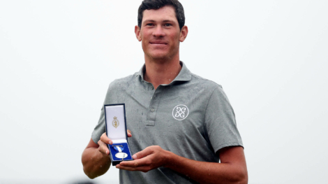 HOYLAKE, ENGLAND - JULY 23: Amateur, Christo Lamprecht of South Africa poses for a photograph with the Low Amateur Silver Medal on the 18th green on Day Four of The 151st Open at Royal Liverpool Golf Club on July 23, 2023 in Hoylake, England. (Photo by Warren Little/Getty Images)